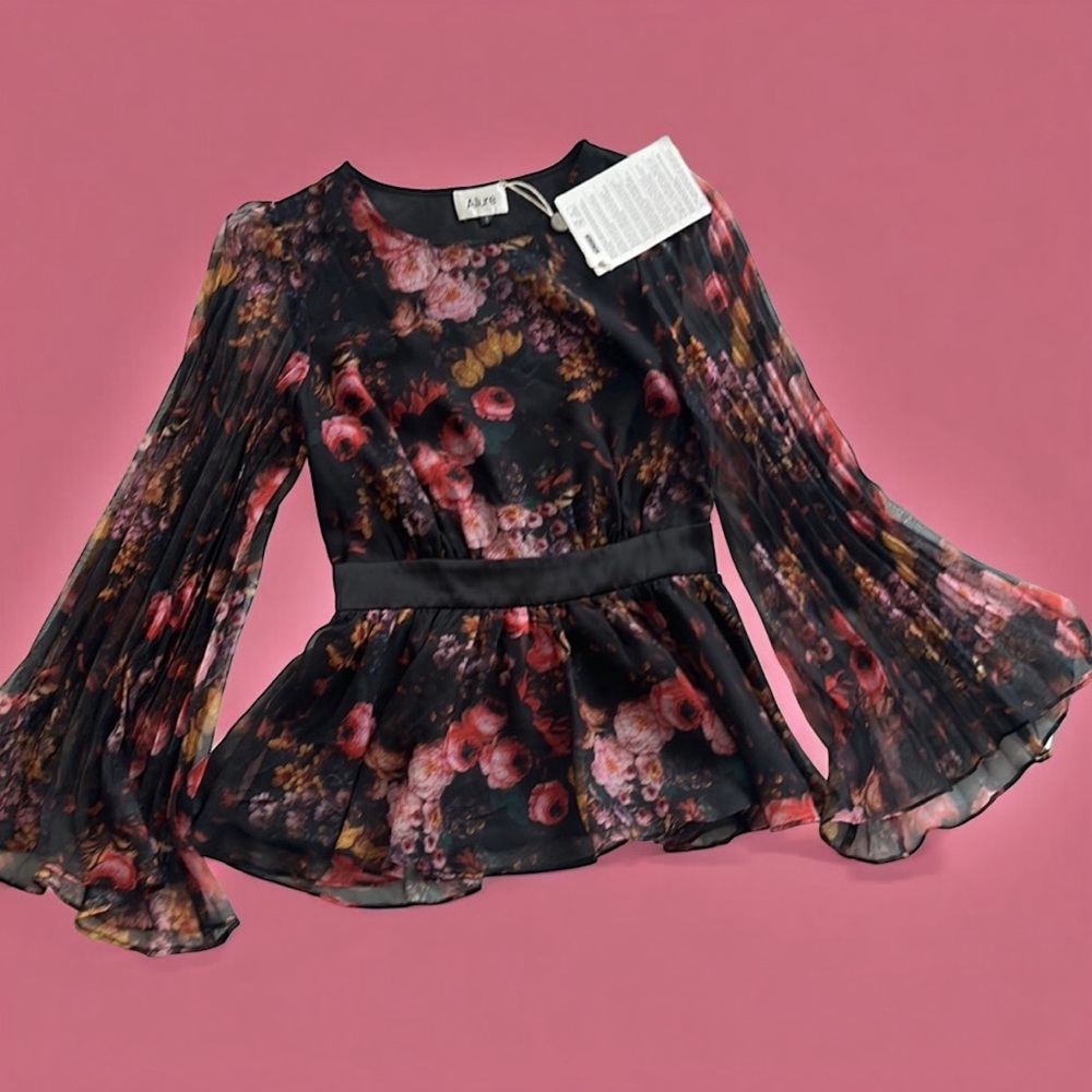 Gorgeous peplum top with flare sleeves. Brand new with tags.